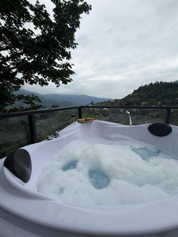 a jacuzzi tub with snow in it with a view at Merisi - Sunset Chalet in Merisi