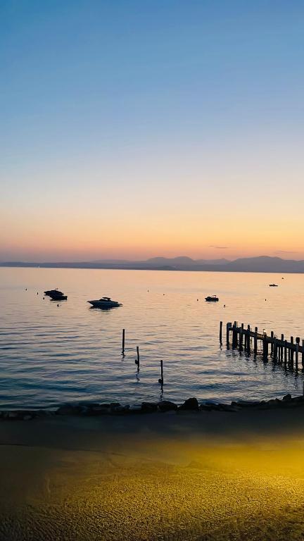 a body of water with a dock in the water at Bardolino Luxury in Bardolino