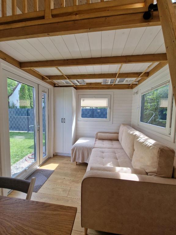 a living room with a couch and some windows at Little Luxe 2 in Amriswil