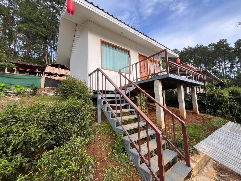 a house with a staircase leading up to it at บ้านซินอัน in Ban Rak Thai
