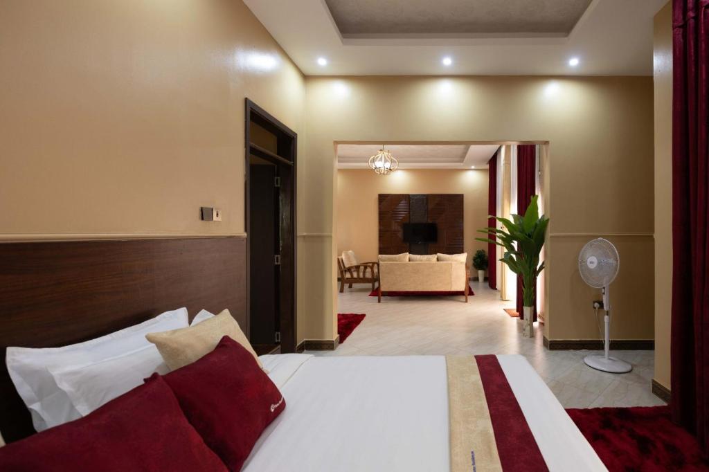 a bedroom with a bed and a living room at Pieme hotel residence 