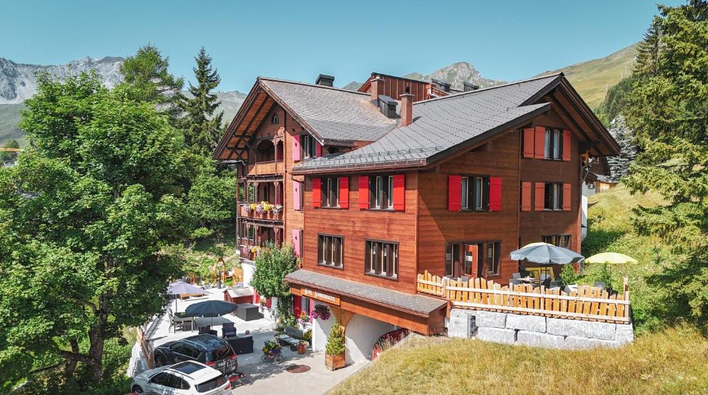 an aerial view of a house with a roof at Hotel Sonnenhalde, Arosa in Arosa