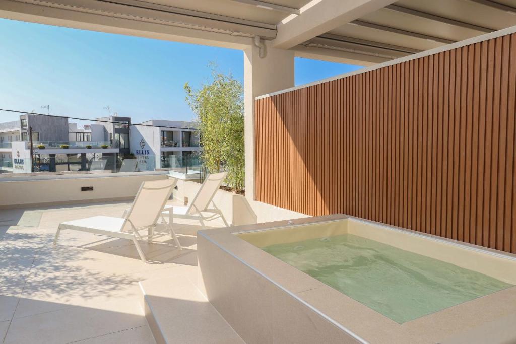 a hot tub on the patio of a house at Sophe Boutique Stay 2 in Kallithea Halkidikis