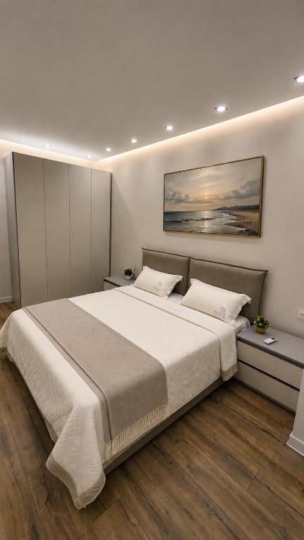 a bedroom with a large bed with two pillows at Lux Apart in Khujand