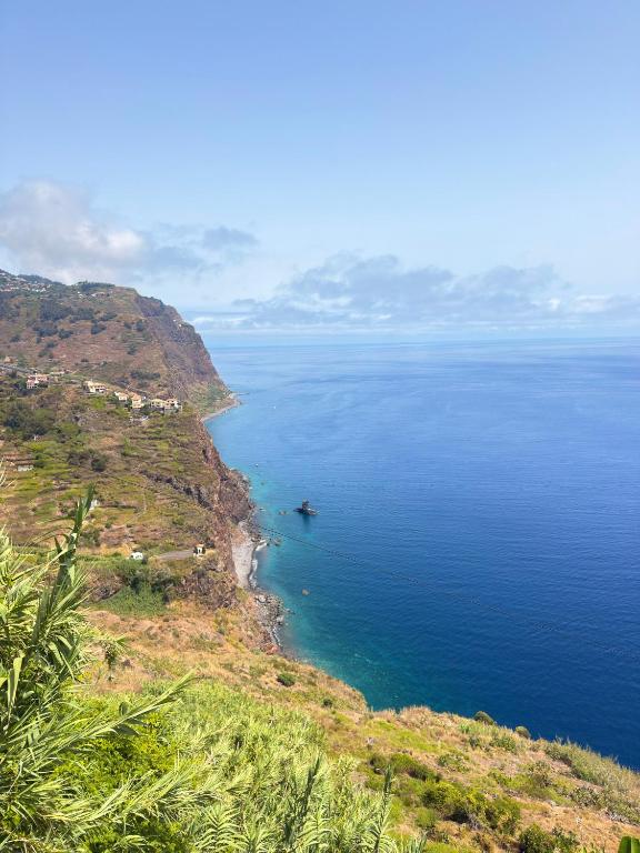 a view of the ocean with a boat in the water at Sea View Pedra Mar in Campanário