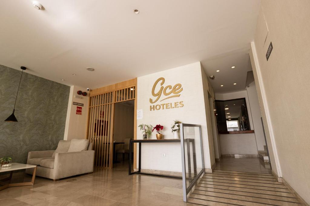 a hotel lobby with a see hotels sign on the wall at Gce Hoteles in Málaga
