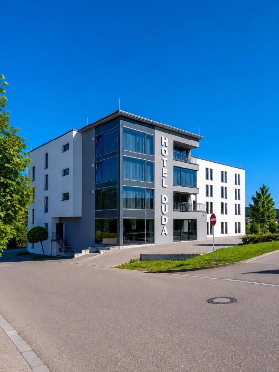 a large white building with a sign on it at Hotel DuDa Langenbruck 3-Sterne-Superior-Hotel an der A9 zwischen Ingolstadt und München in Langenbruck