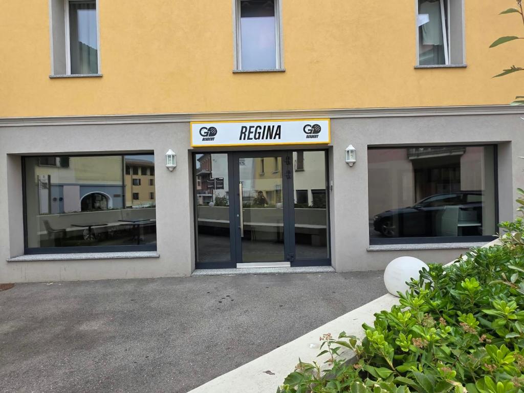 a facade of a building with the entrance to a parking lot at Regina by GoAcademy in Agno