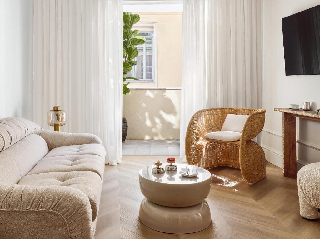 a living room with a couch and a coffee table at ATHENA Pallas in Athens
