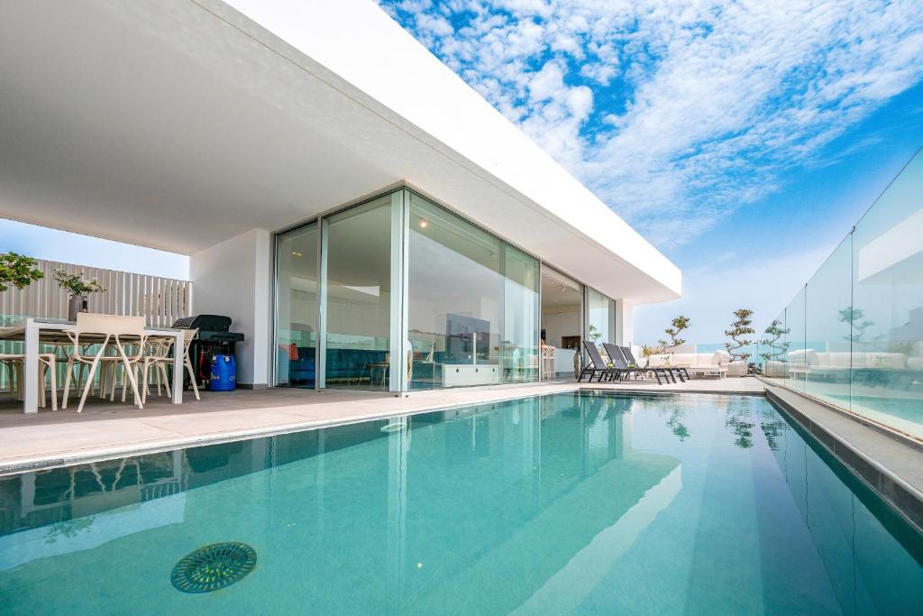 a swimming pool in a house with a view at Villa Veiga with heated pool in Callao Salvaje