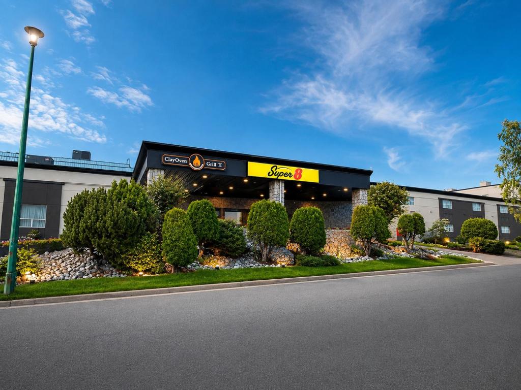 a hotel with a sign on the front of a building at Super 8 by Wyndham Prince George in Prince George