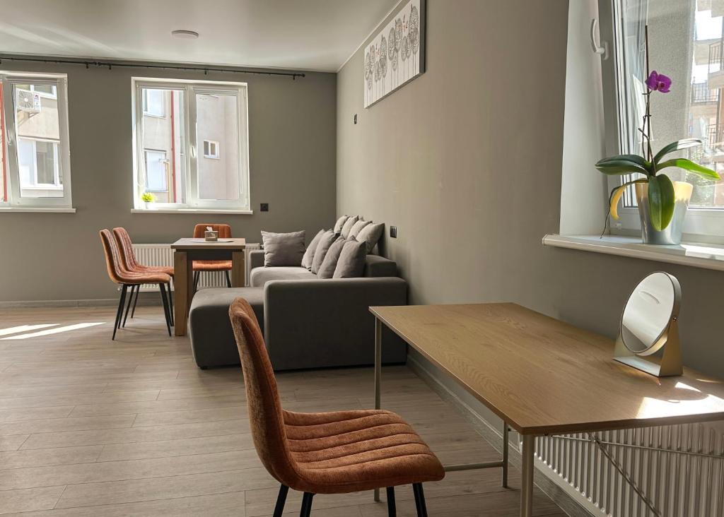 a living room with a couch and a table at Mini home apartment in Ternopil