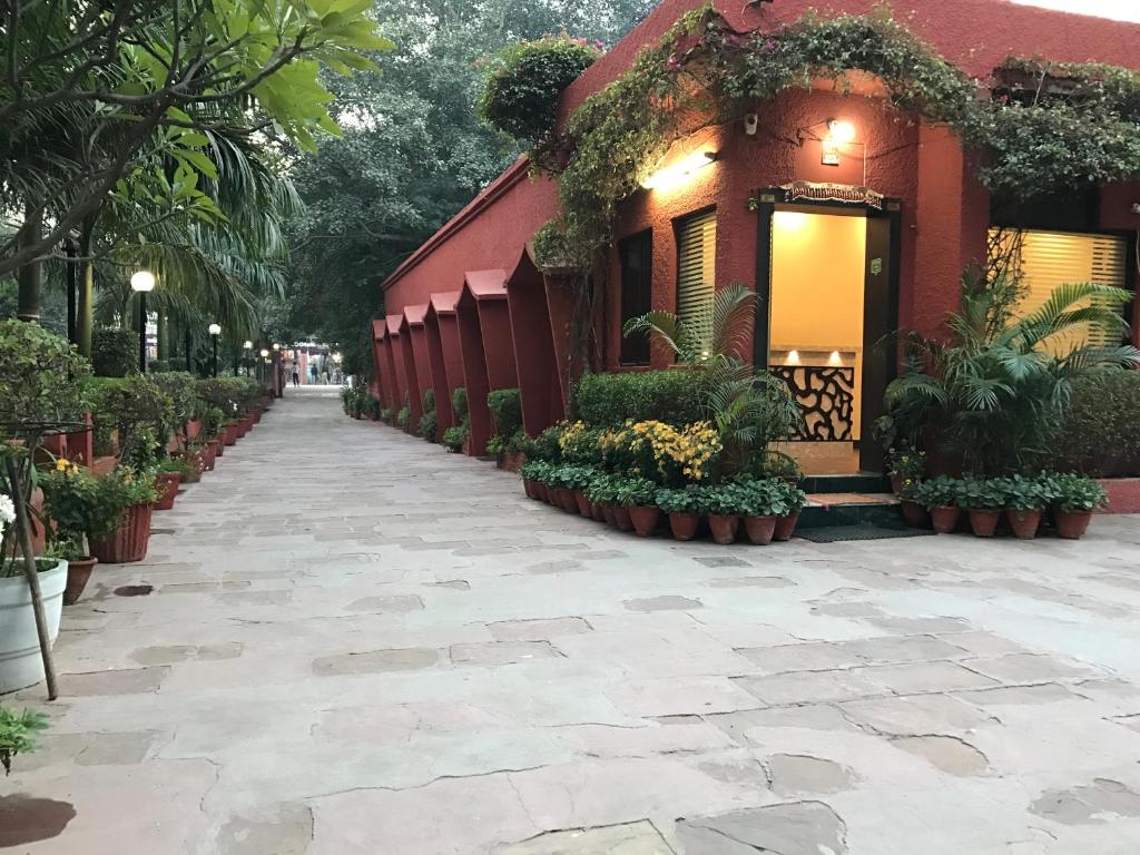 a large garden with flowers and plants in front of a building at Hotel Sheela, 100m from Taj Mahal in Agra