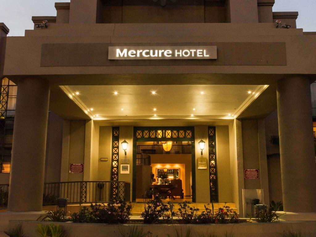 a hotel entrance with a sign that reads temperature hotel at Mercure Hotel Nelspruit in Nelspruit