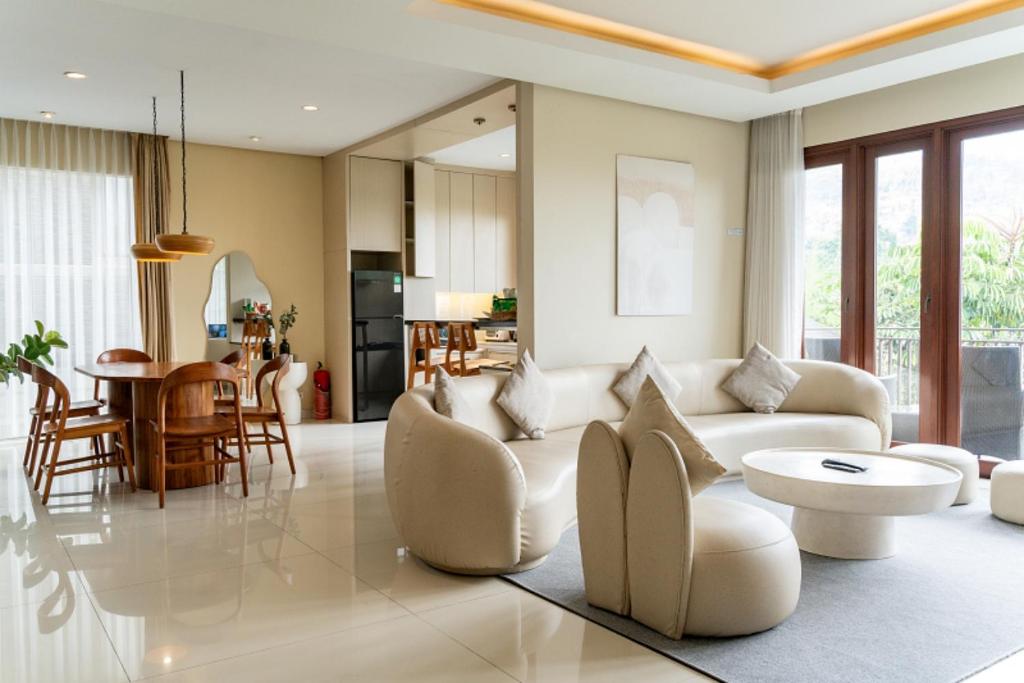 a living room with a white couch and a table at Morning Glory Mountain View Villa 4 Bedrooms With a Private Heated Swimming Pool in Bandung