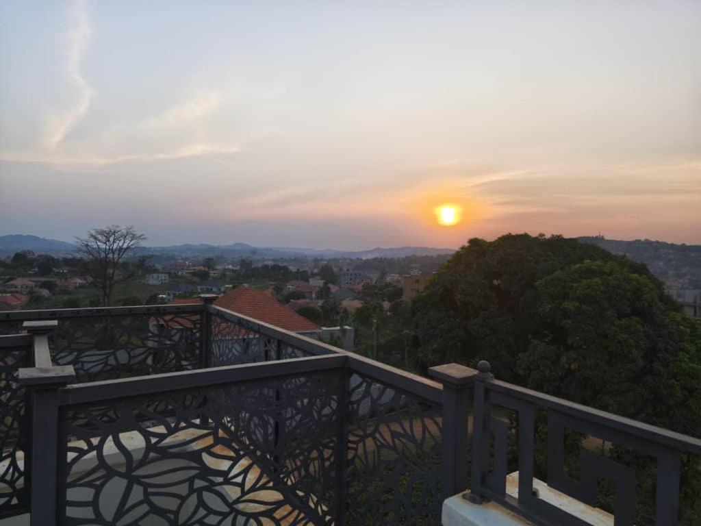 a view of the sunset from a balcony at Henderson Homes Uganda in Sisa