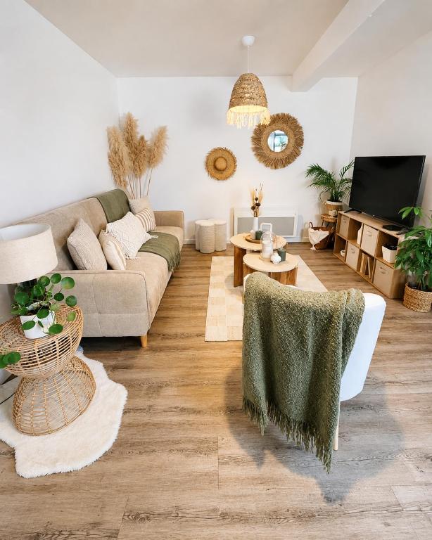 a living room with a couch and a table at Appartement cosy Beaupréau centre in Beaupréau
