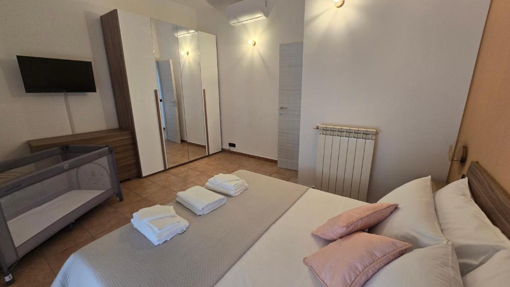 a living room with a white bed and a flat screen tv at Dimora Clorinda in Passo Corese