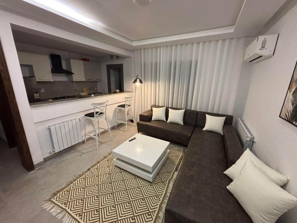a living room with a couch and a table at Jardins de carthage in Tunis