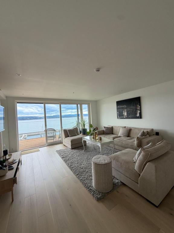a living room with a couch and a table at NORDIQ by the Fjord in Spro