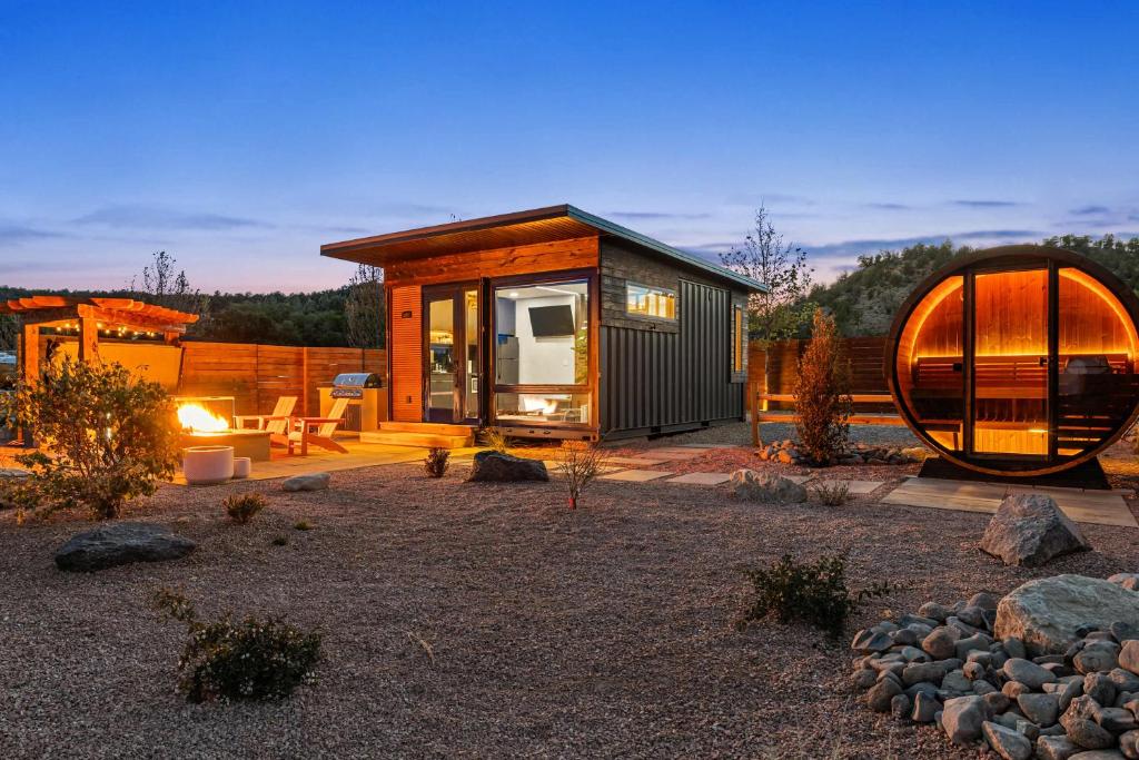 a small cabin with a large window and a round house at ABODE at East Zion in The Fields in Orderville
