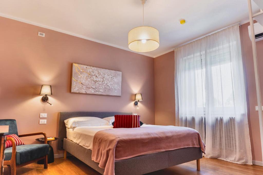 a bedroom with a bed and a window at My Tuscany Pink Suite in San Quirico dʼOrcia