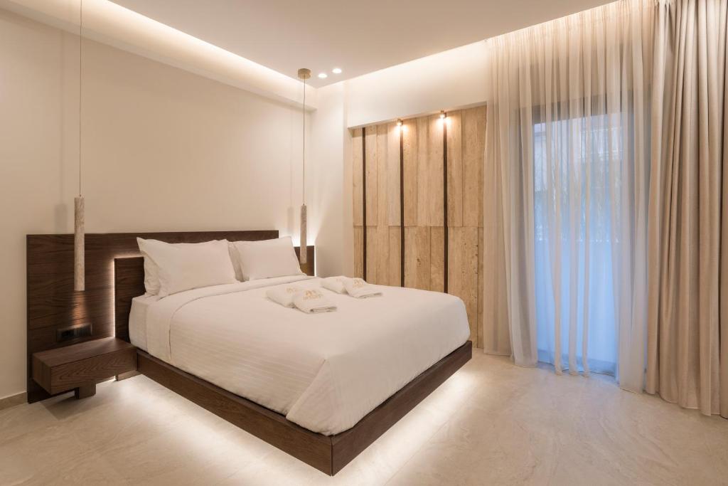 a bedroom with a large bed and a large window at Anthem Suites & Spa in Athens