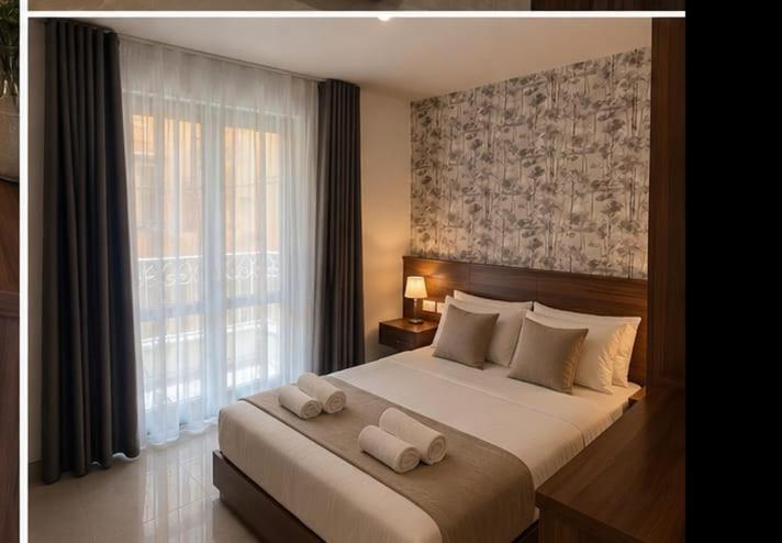 a bedroom with a large bed with two towels on it at Dar Barbara Suites in Birgu