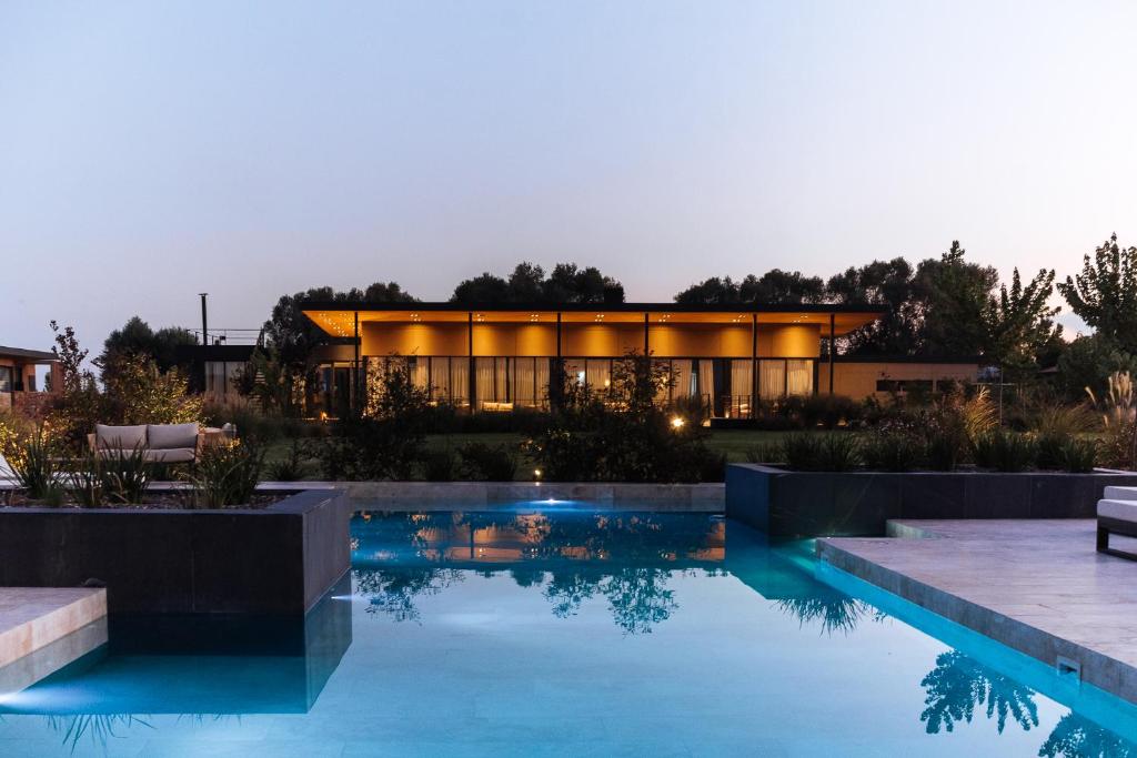 a house with a pool in front of it at Legado Wine Lodge in Maipú