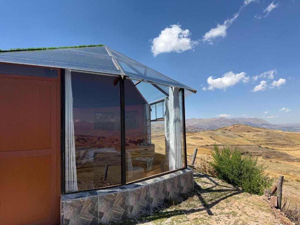 a building with a large window on top of a hill at Sky Dome Peru in Cusco