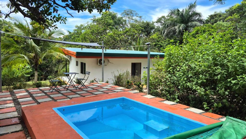 a house with a swimming pool in front of a house at Villas Pura Vida - Marañón in Puntarenas