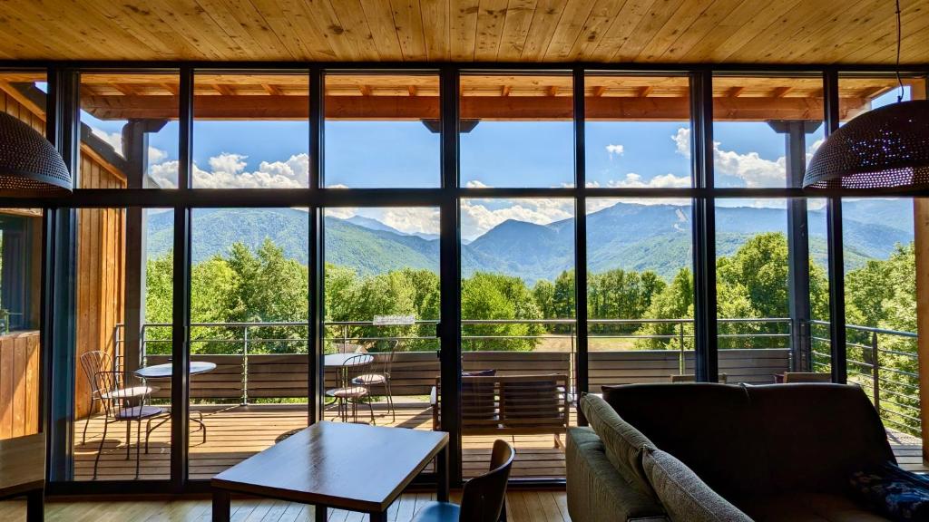 a living room with a view of mountains at Balcons de Sorgeat - Chambres d'hôtes - Ecolodge en montagne in Sorgeat