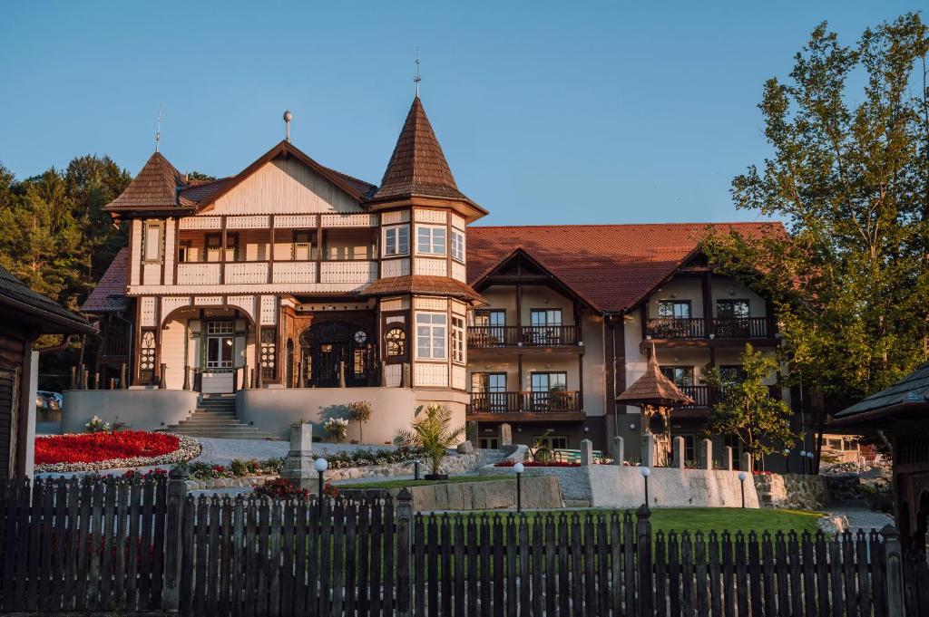 a large house with a fence in front of it at Vila Bernady Sovata in Sovata