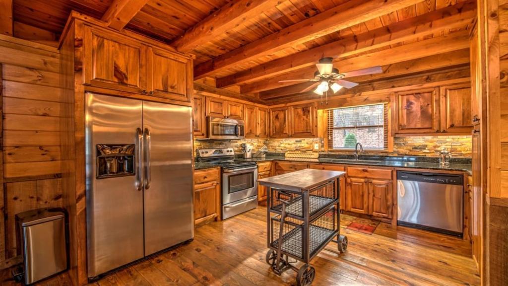 a kitchen with wooden cabinets and a stainless steel refrigerator at Falling Waters in Blue Ridge