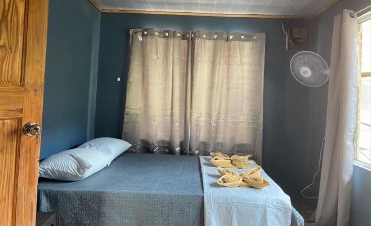 a bedroom with a bed with towels on it at Casa Colibrí #1 in Puerto Jiménez