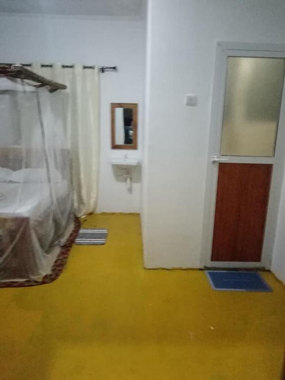 a room with a bedroom with a bed and a bathroom at MafiaSeaview in Kilindoni
