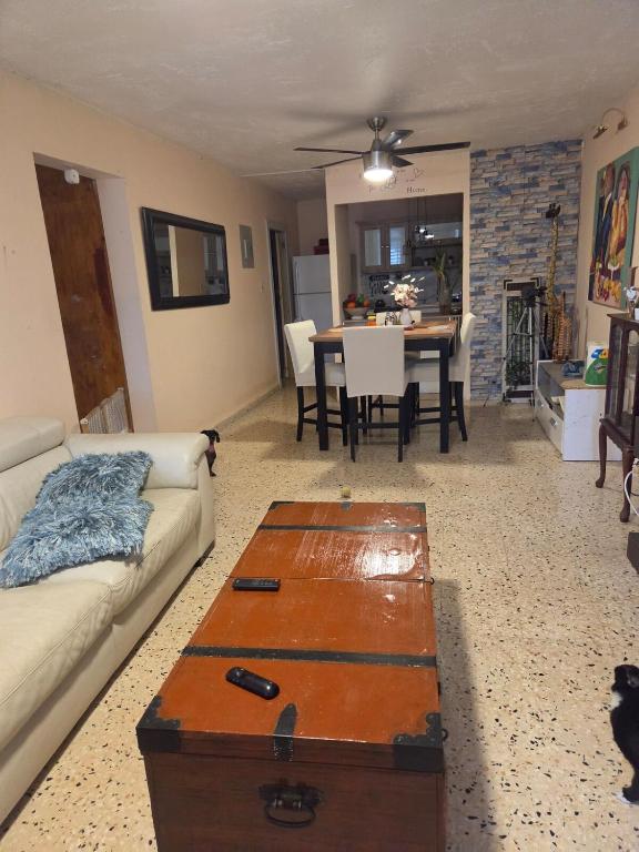 a living room with a couch and a table at La Abuela Hospitality in Dorado