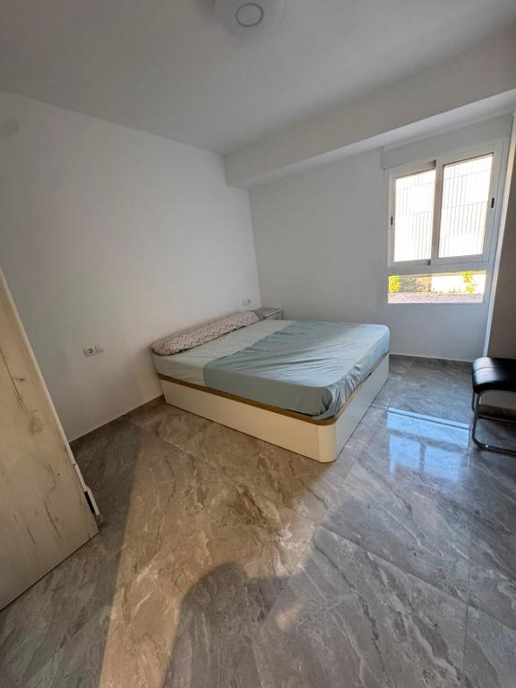 a bedroom with a bed and a chair in it at Maristas in Valencia