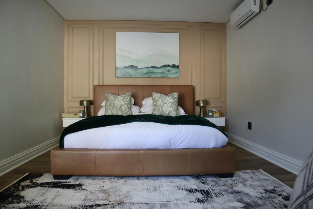 a bedroom with a large bed in a room at Blue Crane Luxury Accommodation in Welkom