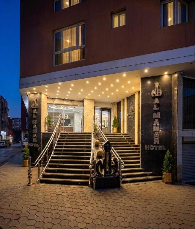 a building with stairs in front of a building with lights at Verssailles Al Manar Hotel in Cairo