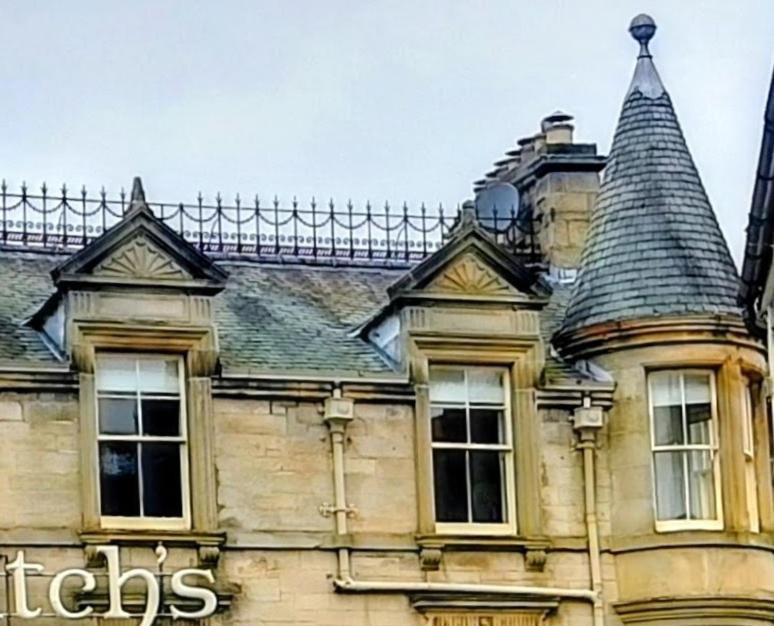 an old building with two windows and a roof at Turret View - spacious central location in Peebles