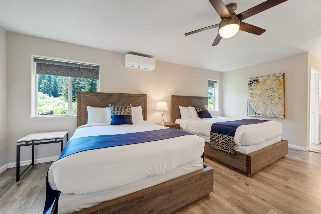 a bedroom with two beds and a ceiling fan at West Sonoma Inn & Spa in Guerneville