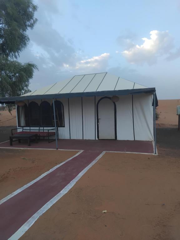 a tent in the middle of a dirt field at Merzouga camelle trike bivoage in Merzouga