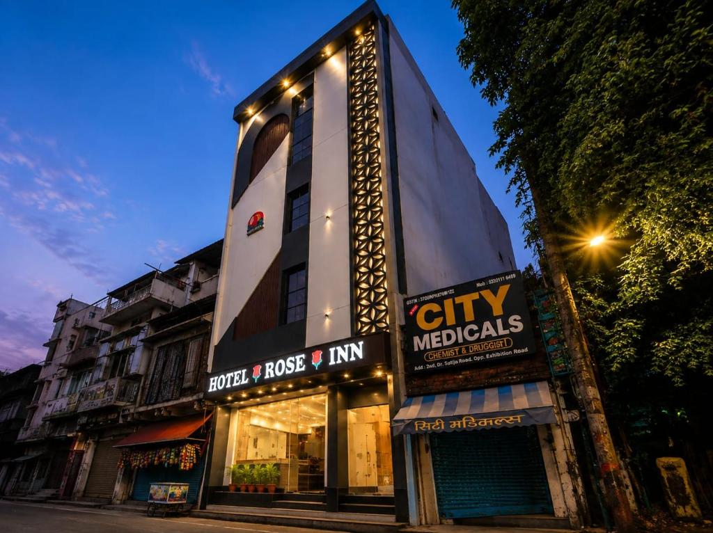a building with lights on the side of it at Hotel Rose Inn in Prayagraj