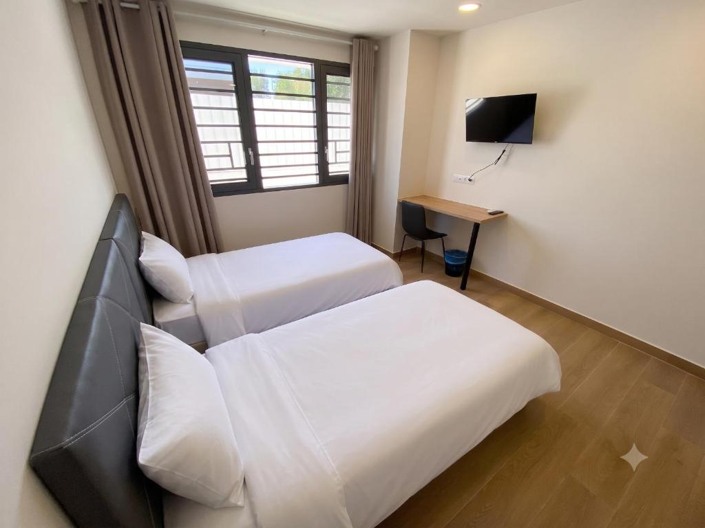 a hotel room with two beds and a television at Hotel A&M Mostoles-Alcorcon-M506 in Alcorcón