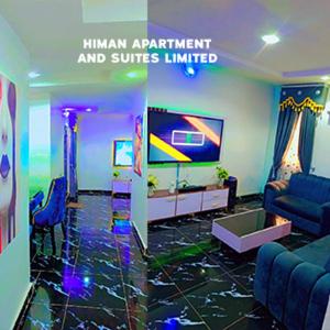 a living room with a couch and a tv at Himan Apartment And Suites in Asipa