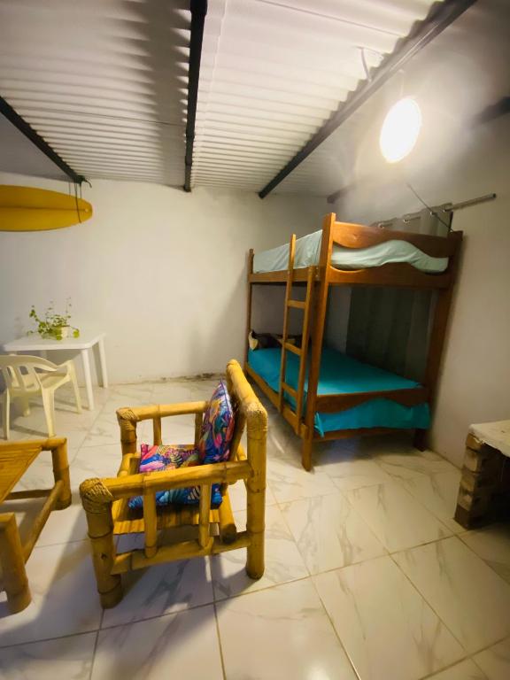a room with two bunk beds and a chair at Holgger House in Talara