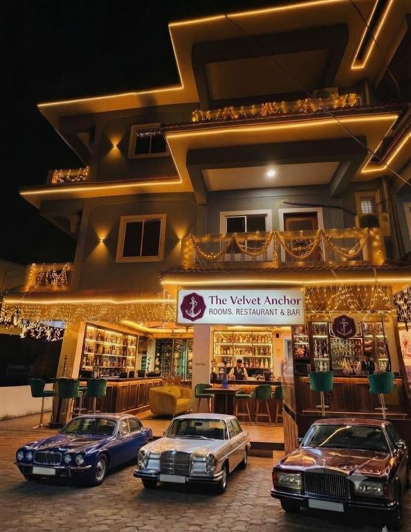 two cars parked in front of a building at The Velvet Anchor in Baga