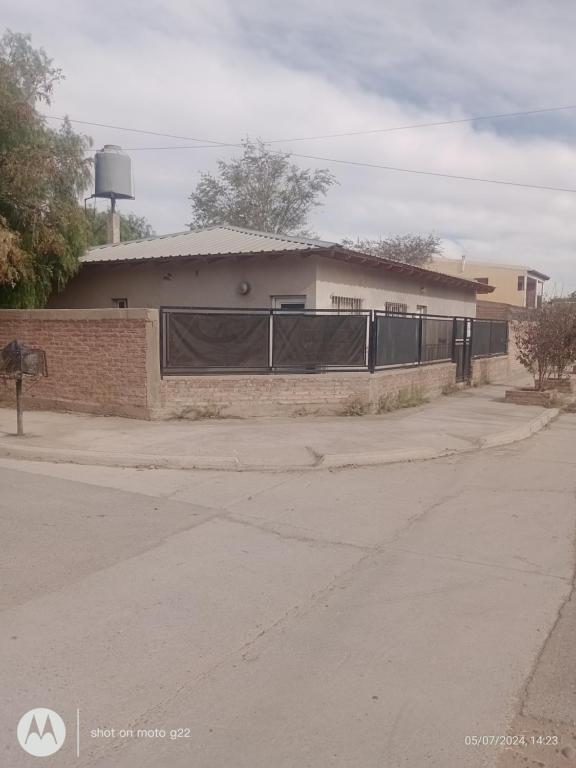 a building with a fence on the side of a road at Marcelo Rivero in Catriel