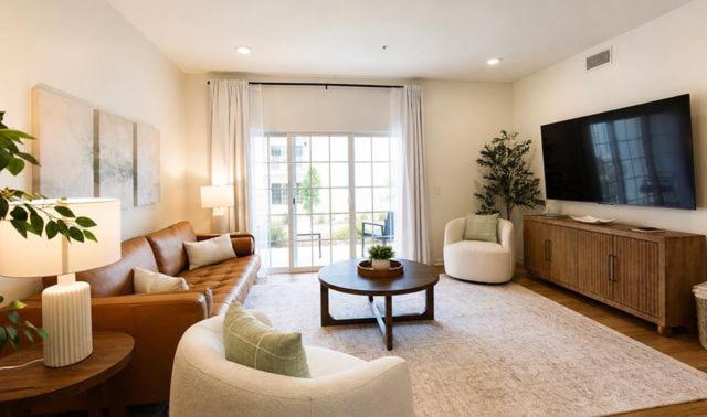 a living room with a couch and a tv at Wlk 2 MSU Fire Pit Pickleball Sleeps 8 in Starkville